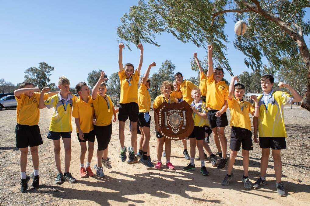Winners: Warialda Public School's under 13s rugby union side proudly hold the Bryan Palmer Shield after returning home champions. Photo courtesy of Adam Marshall.