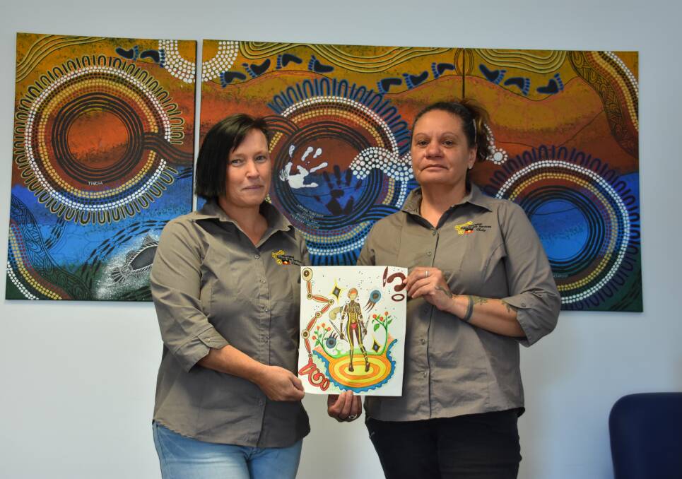 Throwback: Diane Marlow and Aboriginal artist Vicky Duncan with her original design concept for the 2018 Inverell NAIDOC Week shirts.