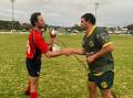 Changing hands: Inverell captain Luther Robinson accepts the Kookaburra Challenge Cup from Gunnedah counterpart James Perrett after their nail-biting win on Saturday.