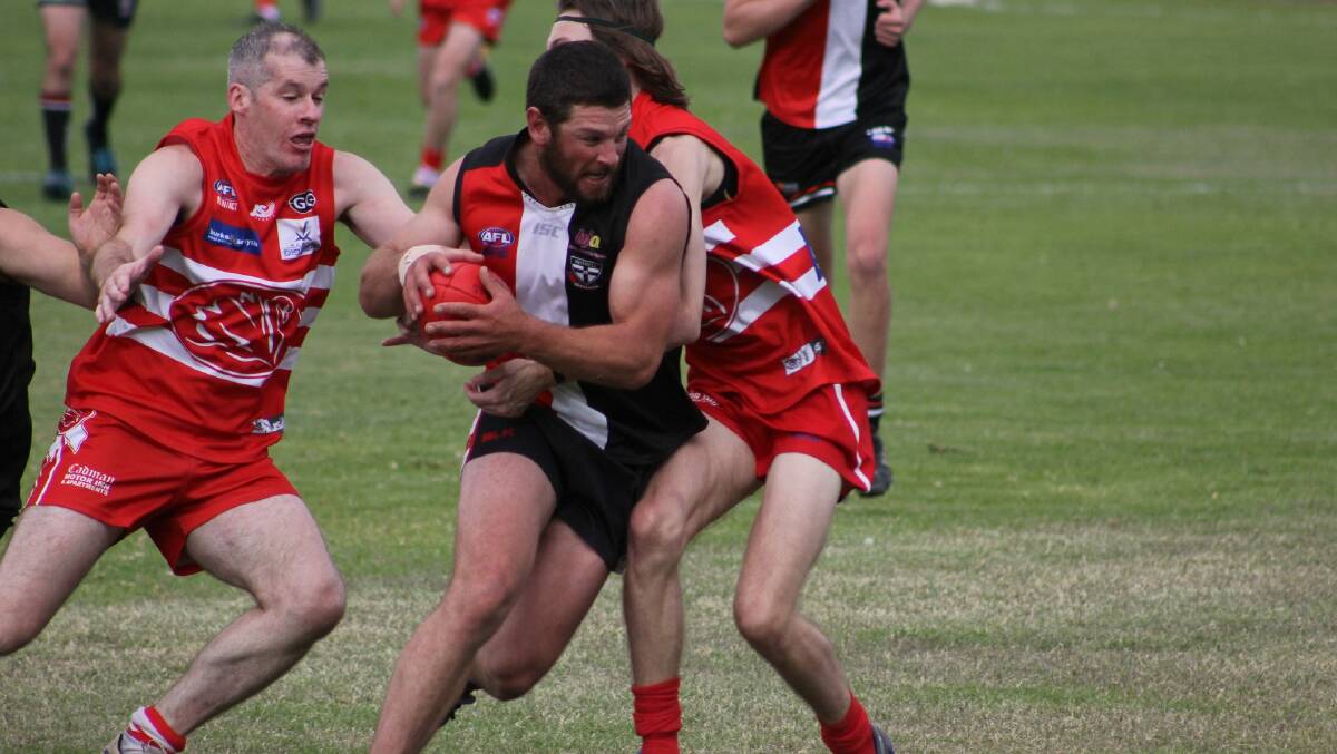STRONG START: Cameron Patch tries to break through a tackle in the Saints 34-point win over the Tamworth Swans. Photo: Kaitlin Beveridge.