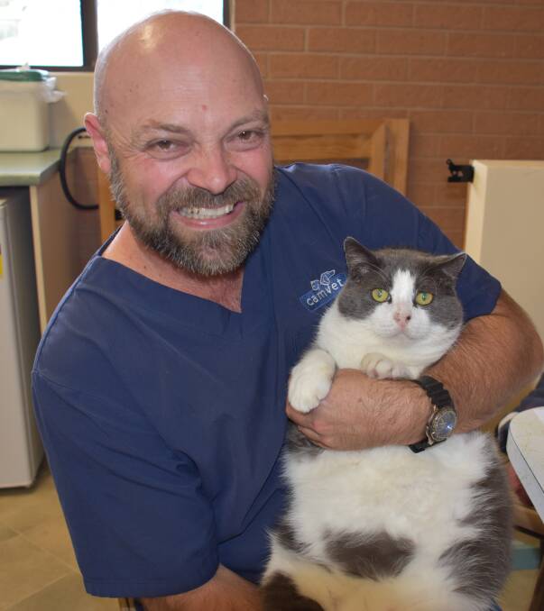 Gavin Rippon with Camvet's adopted stray Kevin. Kevin is two kilograms overweight. 