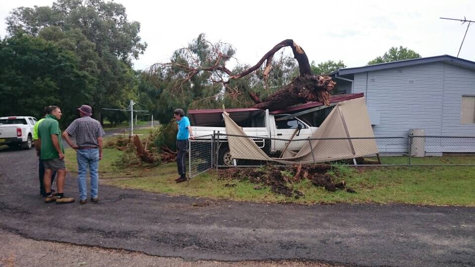 DISASTER STRIKES: Dean Furner's carport was destroyed when a tree fell during violent storms in February. Mr Furner fronted Inverell Shire Council today with residents Val Lederhose and Ivy Campbell calling to the trees to be pruned.