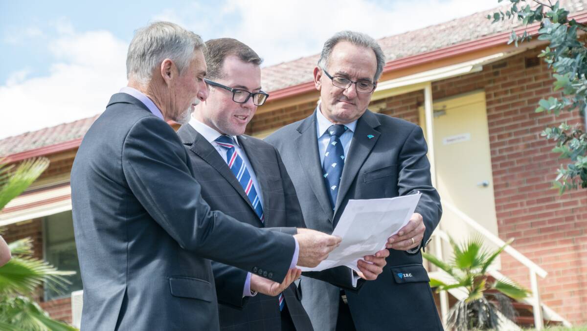 DESIGNS ANNOUNCED: Mayor Paul Harmon, MP Adam Marhsall and deputy mayor Anthony Michael peruse the detailed plans of the designs for the $30 million Inverell Hospital redevelopment on Monday.