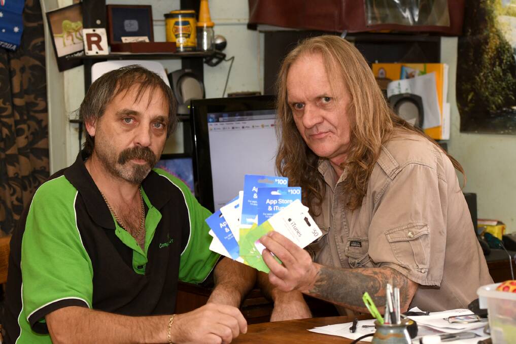 GUTTED: Horsham's Mick Parish and Craig Kroker. Craig, who is on a pension, was scammed $6k and forked out $2k for iTunes gift cards. Picture: SAMANTHA CAMARRI