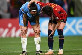 England's Lucy Bronze is consoled by Ona Batille of Spain after the final. (Dan Himbrechts/AAP PHOTOS)