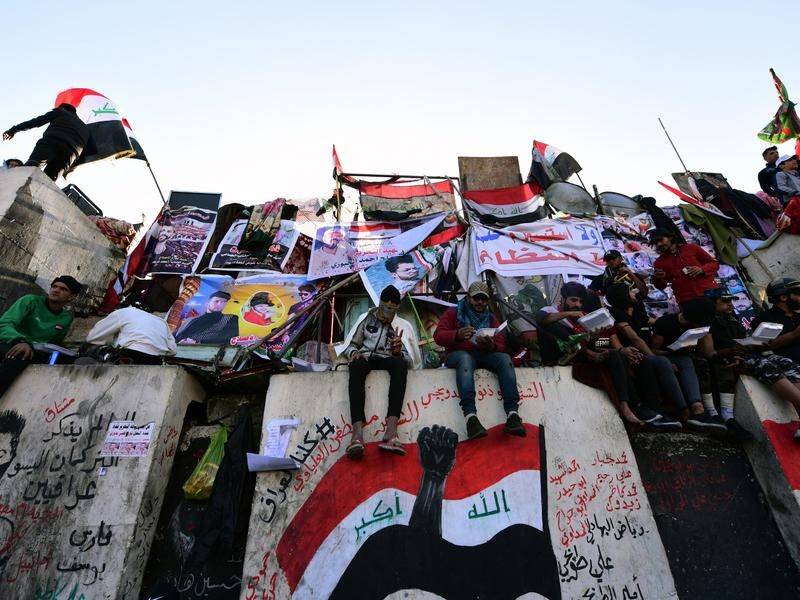 Four Iraqi protesters have been killed during overnight clashes in Baghdad, officials say.