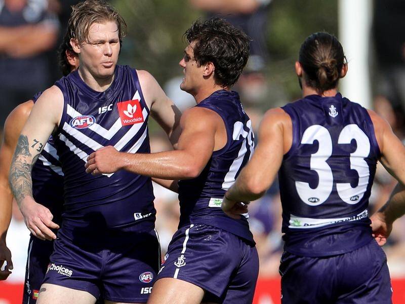 Fremantle's Cam McCarthy (l) is in hospital after collapsing at AFL training.