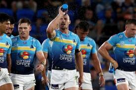 Gold Coast captain Kieran Foran (centre) is in top form and keen to play on in 2025. (Jason O'BRIEN/AAP PHOTOS)