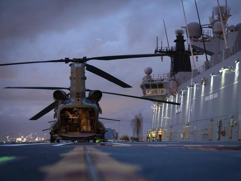 Chinook helicopters have been loaded onto HMAS Adelaide, which is set to leave Brisbane for Tonga.