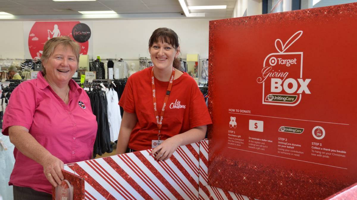 GIVING 2014: Reverend Jean Bell with Target manager Samantha Hoffman beside Target's 2014 Christmas giving box. Picture by STEVE GREEN