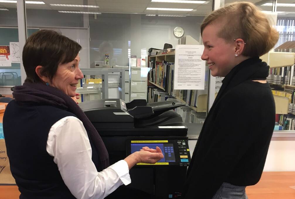 NEW GEAR: Naomi Radford shows Mia Clayton how to use the new printing system. Photo: Contributed.