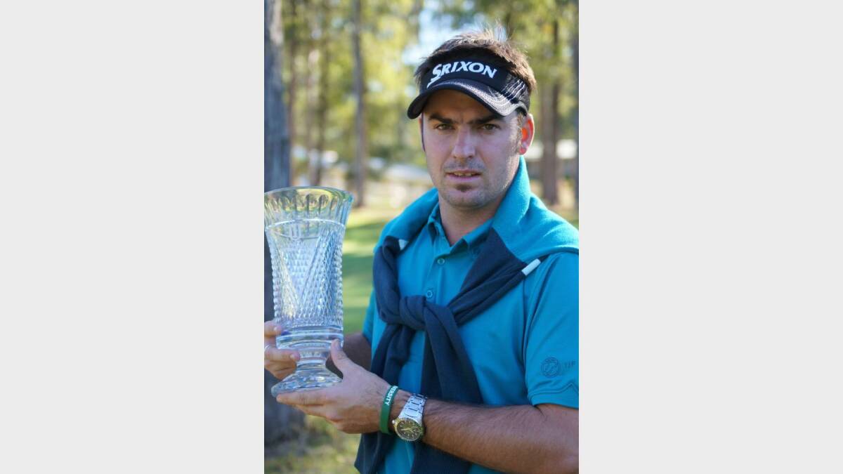 ON THE WAY: Inverell’s professional golfer Brett Drewitt holds the trophy from his win in China.