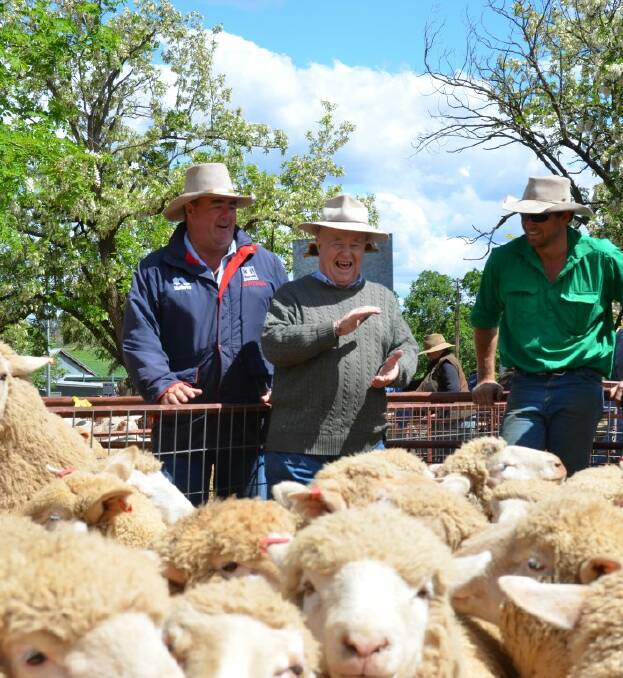 SOLD: Brian Baldwin at the saleyards with Phil Hallam and Chad Makim, who is the fourth generation from his family who Brian has auctioneered for.