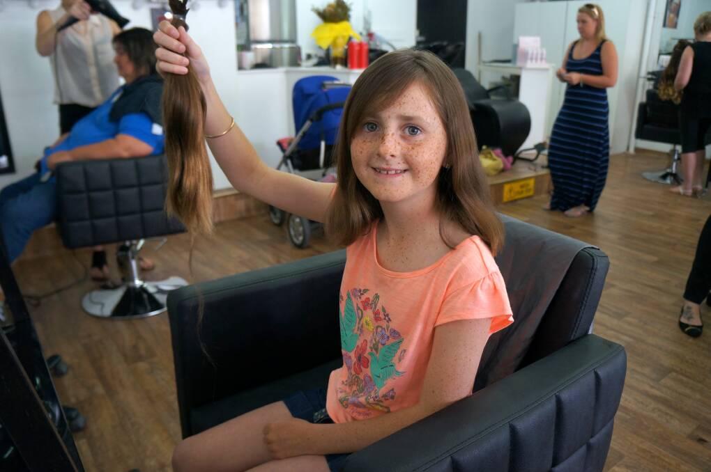 GOOD CAUSE: Eleven-year-old Macey Clarke with her ponytail, soon to be part of a free wig for a cancer patient.