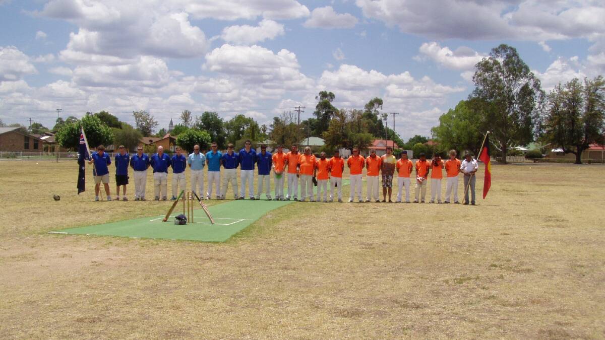 Players bow their heads to honour Phillip Hughes at Tingha.