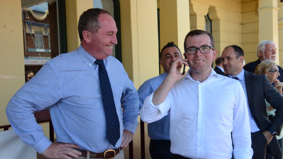 NO BLACK SPOT: Barnaby Joyce looks on whilst Adam Marshall receives a phone call with Vodaphone coverage in Glen Innes town square today.