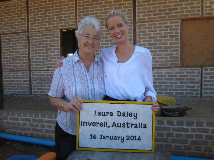 Rosemary and Laura with the plaque that would soon be placed on a village water tank.