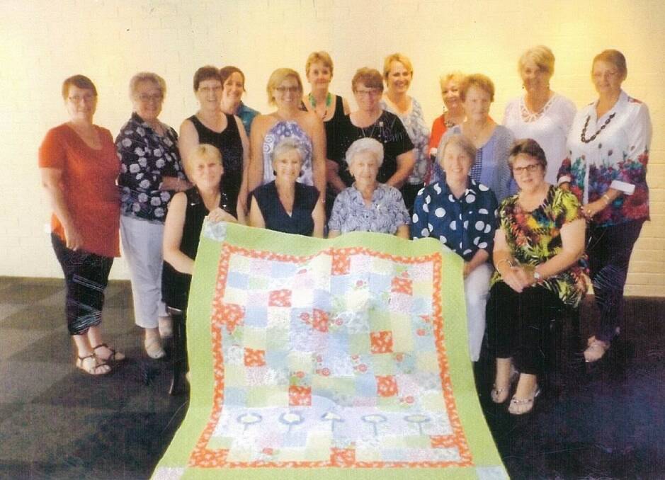 CREATIVITY: Women of the Delungra Quilters group with the piece created by many hands. Photo contributed by Janice Uebergang