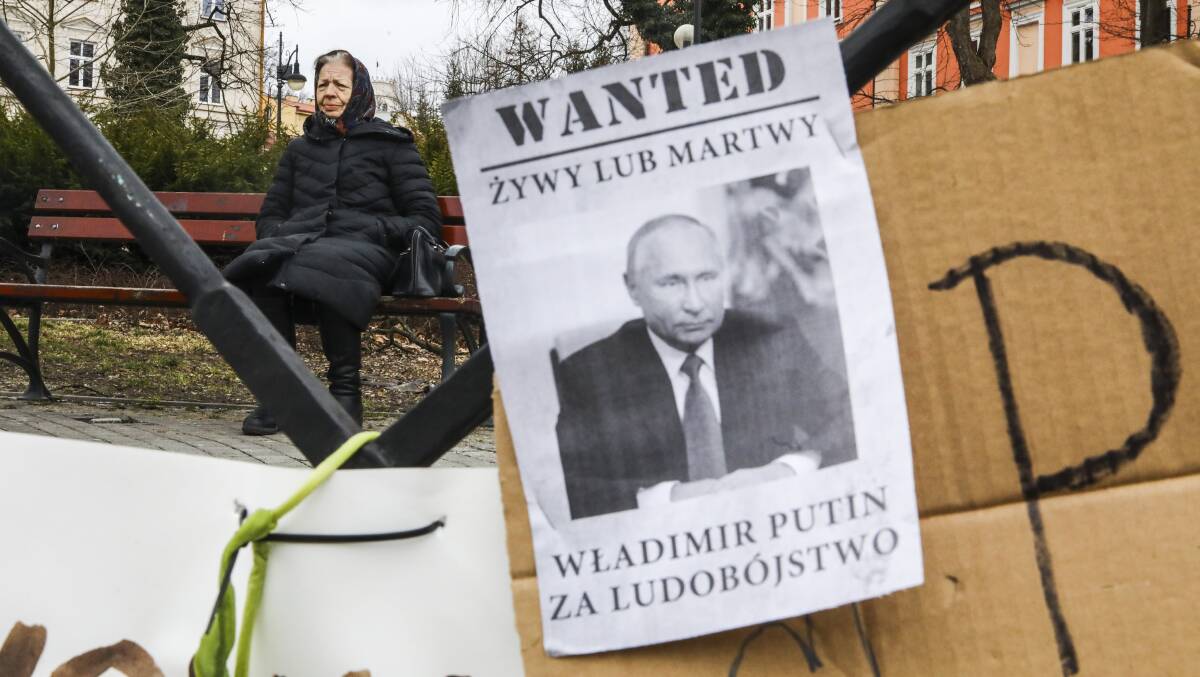 A sign reading "Wanted Dead or Alive: Vladimir Putin for genocide" is seen in Przemysl, Poland on March 5. Picture: Getty Images