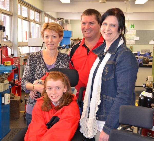 AT SCHOOL: Amber Dennis (front) at school this week with her mother Angela Dennis, teacher Glen Partridge and Amanda’s carer Amanda Dean.