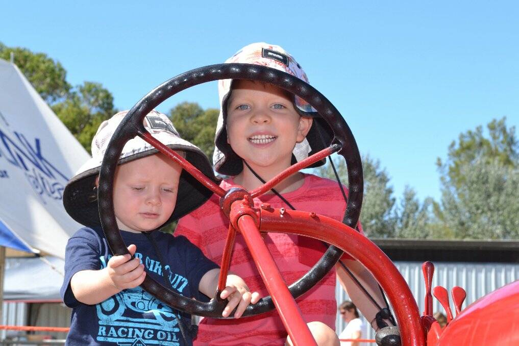 Harrison and Sebastian McDonald, checking out the antique Farmall tractor.